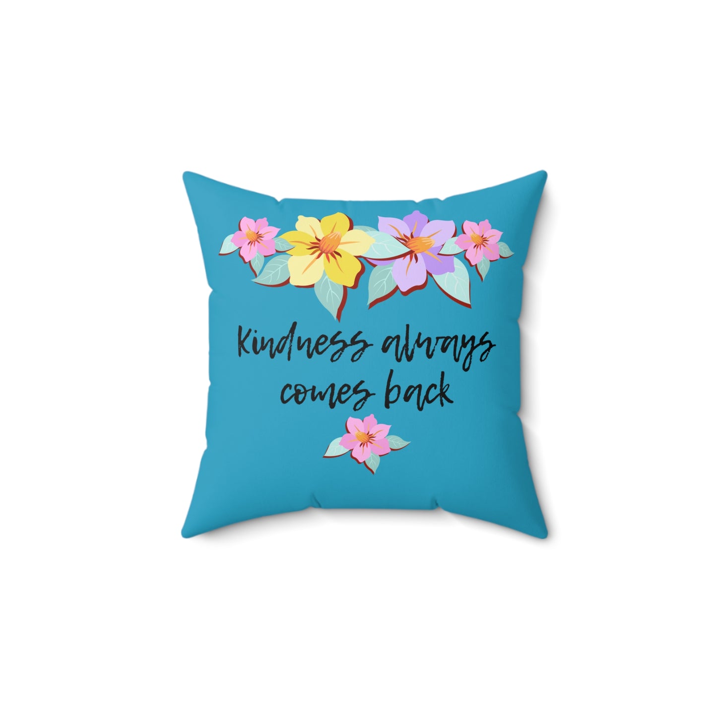 Almohada azul motivacional con motivo de flores y cita inspiradora "La bondad siempre vuelve"