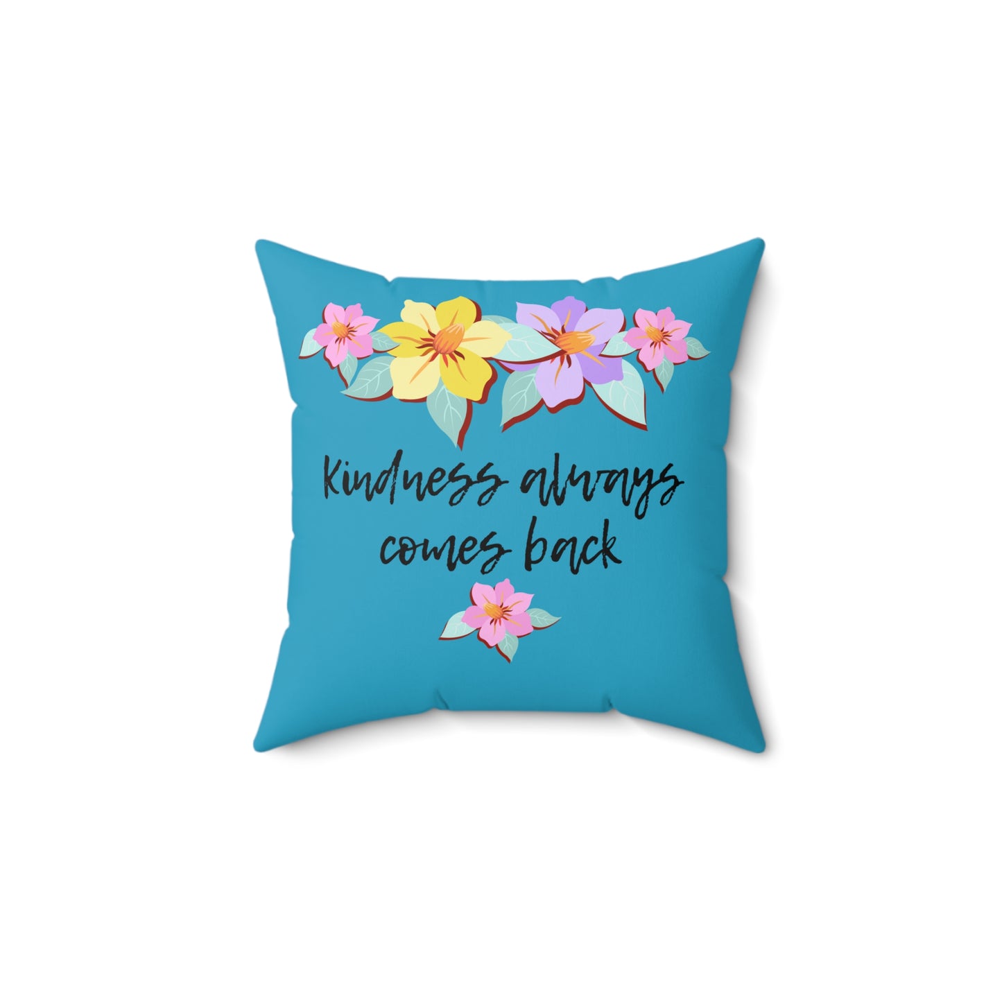 Almohada azul motivacional con motivo de flores y cita inspiradora "La bondad siempre vuelve"