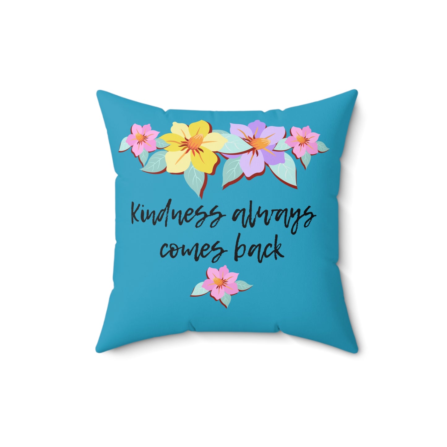 Almohada azul motivacional con motivo de flores y cita inspiradora "La bondad siempre vuelve"