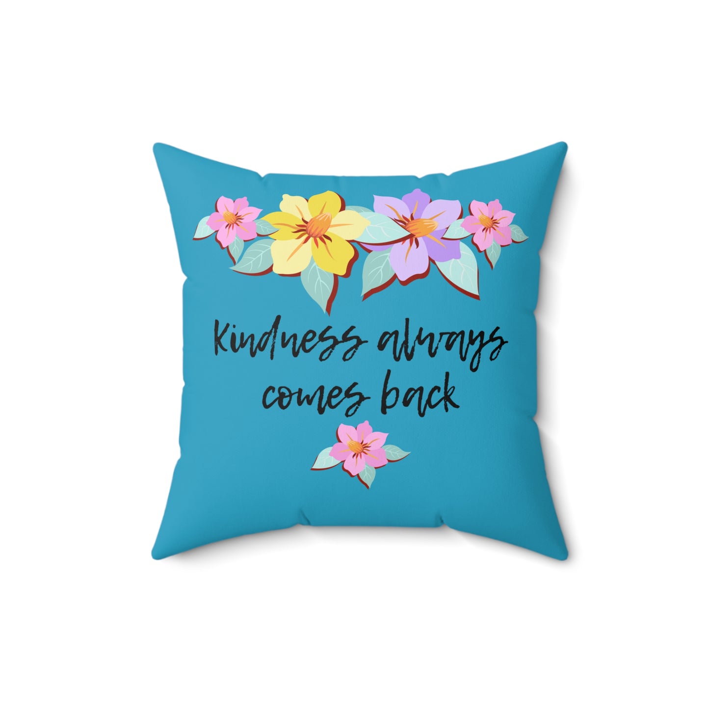 Almohada azul motivacional con motivo de flores y cita inspiradora "La bondad siempre vuelve"