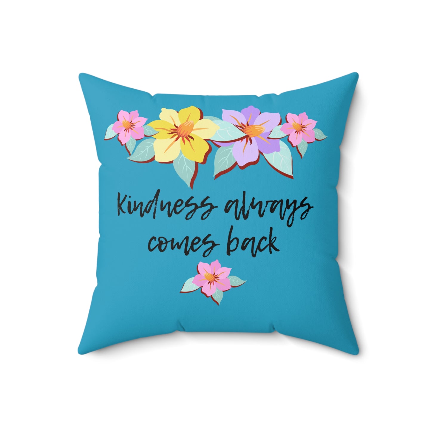 Almohada azul motivacional con motivo de flores y cita inspiradora "La bondad siempre vuelve"